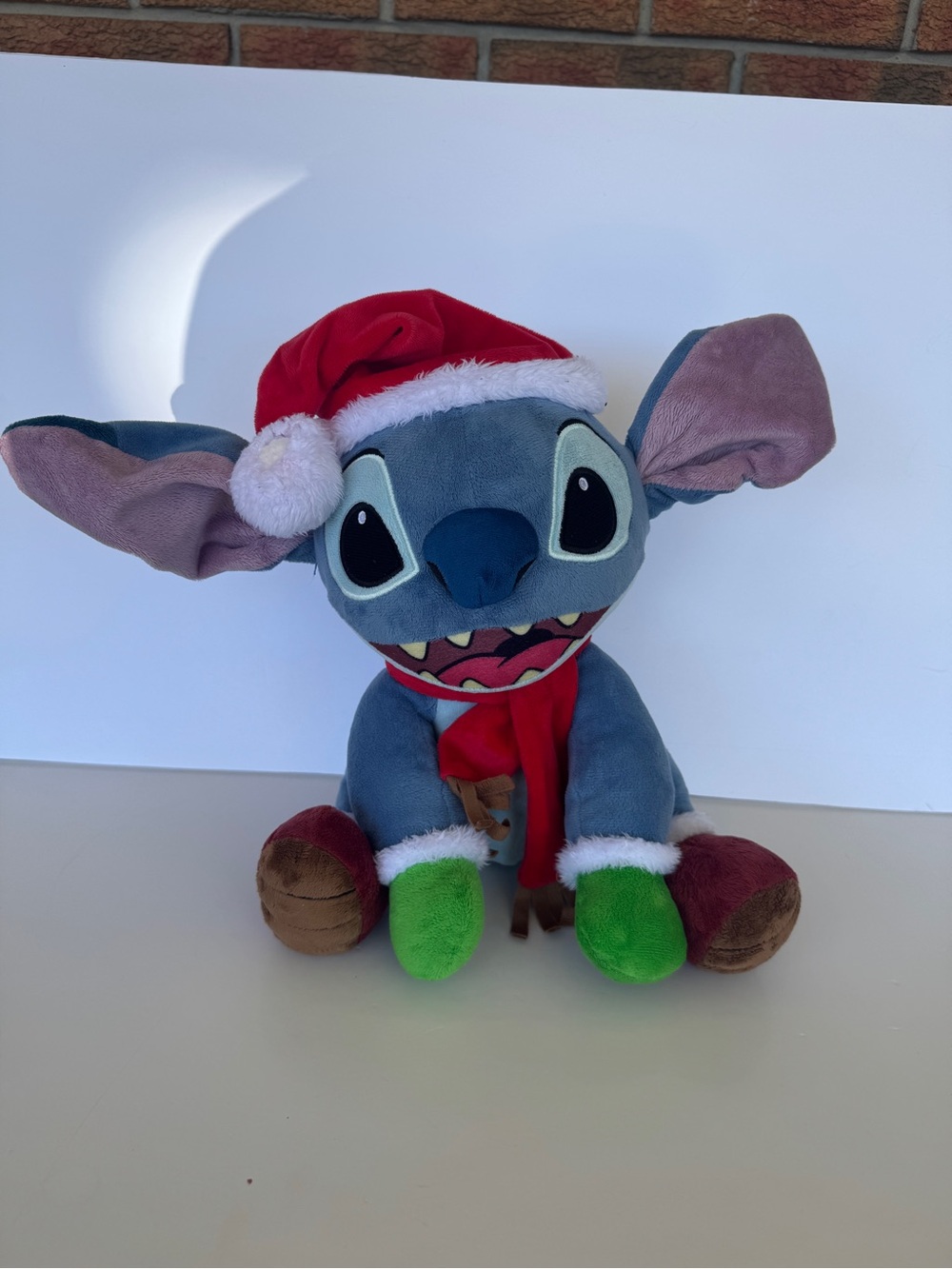 Disney Christmas Stitch Plush in Blue with Red Hat and Green Paw Accents